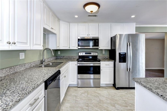 1413 Seward Dr, Hampton, VA 23663 - kitchen featuring visible vents, light stone countertops, appliances with stainless steel finishes, white cabinetry, and a sink