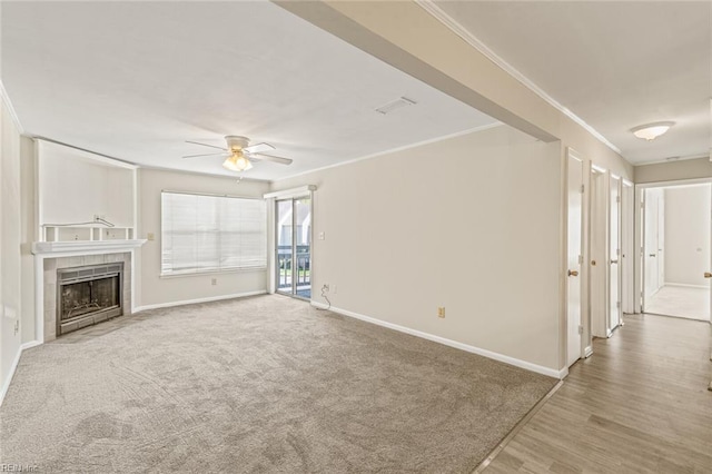 3955 Palomino Dr Unit 201, Newport News, VA 23602 - unfurnished living room featuring ornamental molding, carpet, baseboards, ceiling fan, and a tiled fireplace