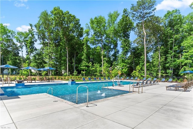 community pool featuring a patio and fence