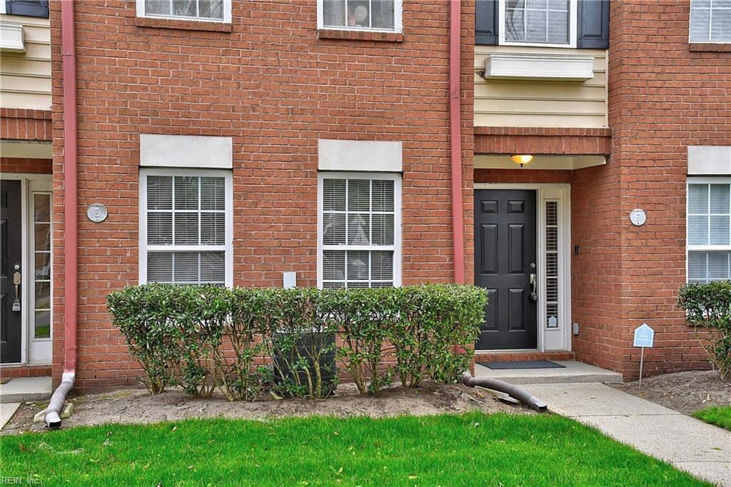 doorway to property featuring brick siding