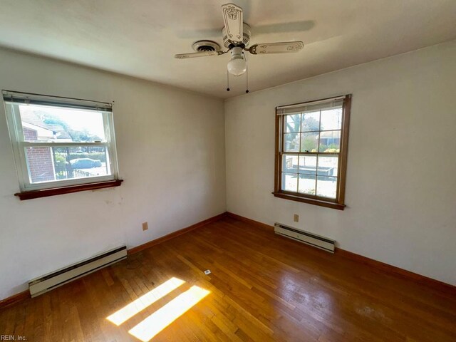 unfurnished room with ceiling fan, a baseboard radiator, baseboards, and wood finished floors
