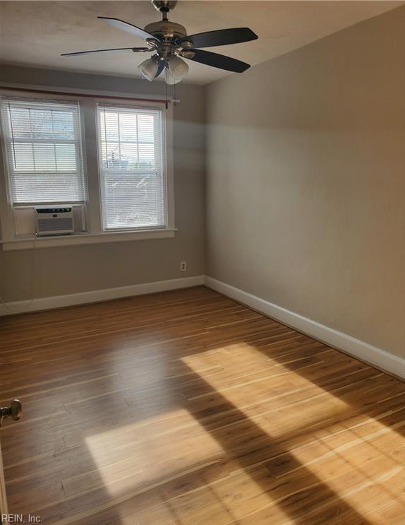 spare room featuring baseboards, a ceiling fan, and wood finished floors