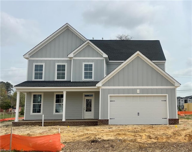 view of front of house with an attached garage, board and batten siding, and a porch