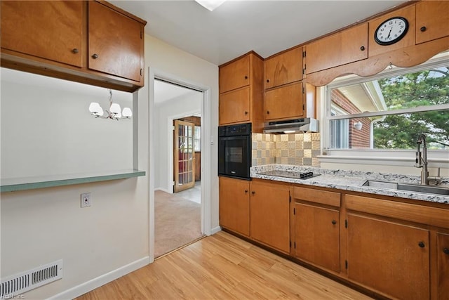 8084 Lynnbrook Dr, Norfolk, VA 23518 - kitchen featuring black appliances, light wood-style floors, a sink, decorative backsplash, and brown cabinets