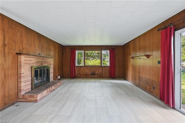 8084 Lynnbrook Dr, Norfolk, VA 23518 - unfurnished living room with wood walls and a brick fireplace