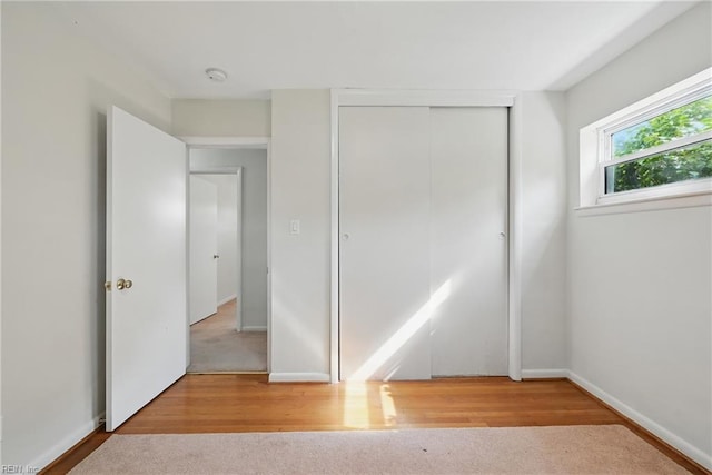 8084 Lynnbrook Dr, Norfolk, VA 23518 - unfurnished bedroom with a closet, wood finished floors, and baseboards