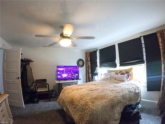 bedroom featuring a ceiling fan and dark carpet