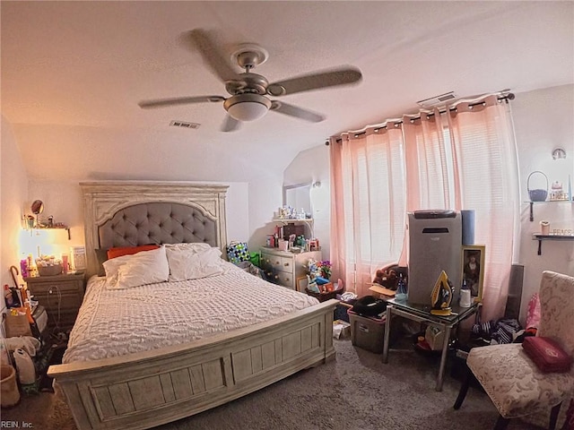 carpeted bedroom with a ceiling fan, vaulted ceiling, and visible vents
