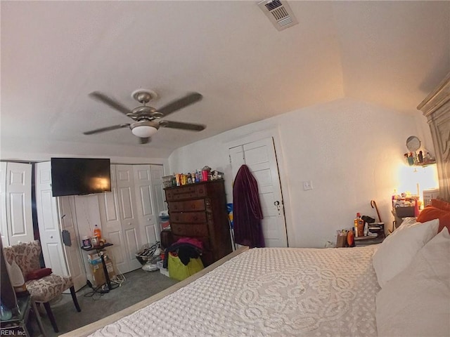 carpeted bedroom with ceiling fan, multiple closets, and visible vents