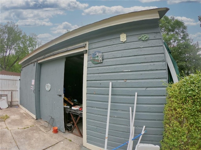 view of outbuilding featuring an outbuilding and fence