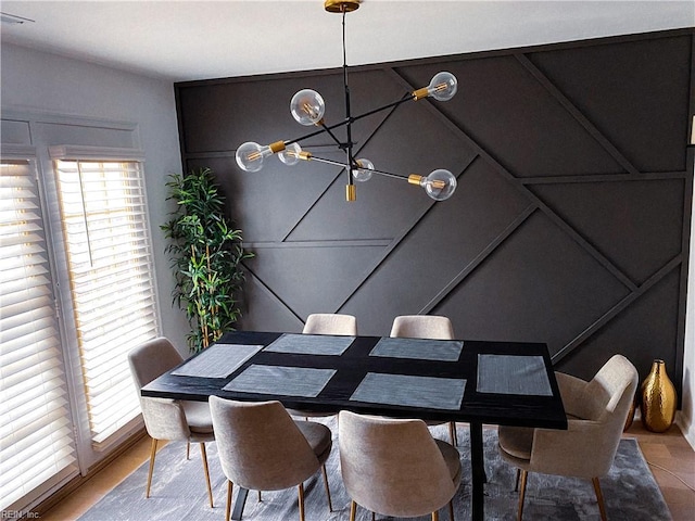 dining room with a wealth of natural light and an inviting chandelier