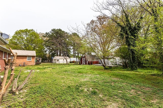 view of yard with an outdoor structure and fence