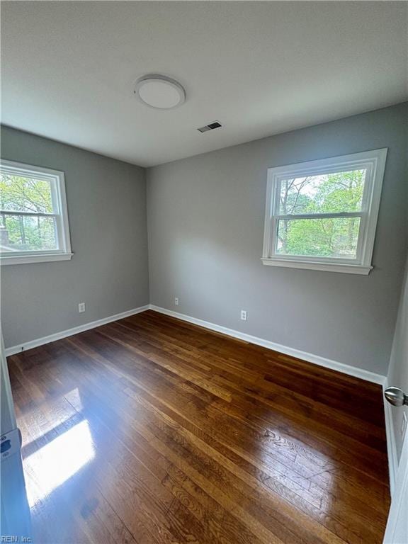 97 Waterview Dr, Newport News, VA 23608 - empty room with baseboards, dark wood-style flooring, visible vents, and a healthy amount of sunlight