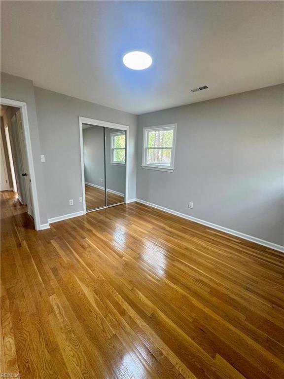 97 Waterview Dr, Newport News, VA 23608 - unfurnished bedroom with wood finished floors, a closet, baseboards, and visible vents