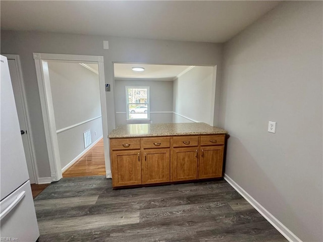 97 Waterview Dr, Newport News, VA 23608 - kitchen with visible vents, brown cabinetry, dark wood-type flooring, and freestanding refrigerator