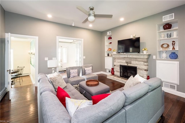 living area with dark wood-type flooring, built in features, ceiling fan, and visible vents