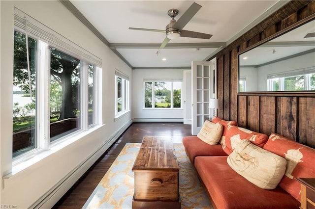 sunroom / solarium with baseboard heating, crown molding, a healthy amount of sunlight, and wood finished floors