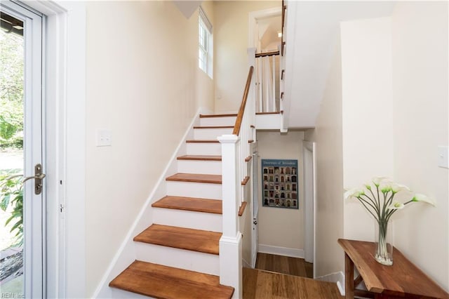 stairs with baseboards and wood finished floors