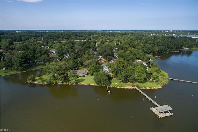 drone / aerial view with a water view and a wooded view