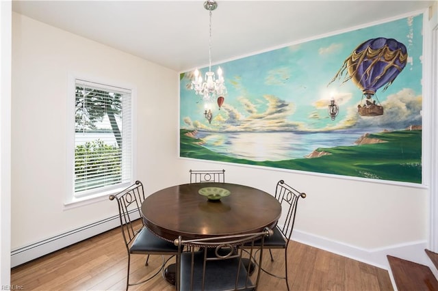 dining space featuring a notable chandelier, wood finished floors, and baseboard heating