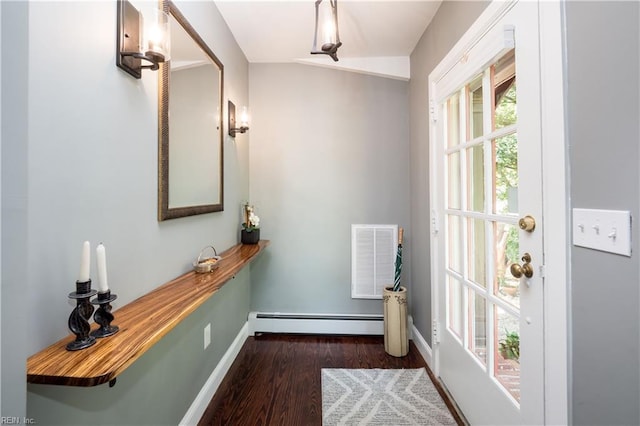 doorway to outside featuring visible vents, a baseboard radiator, baseboards, and wood finished floors