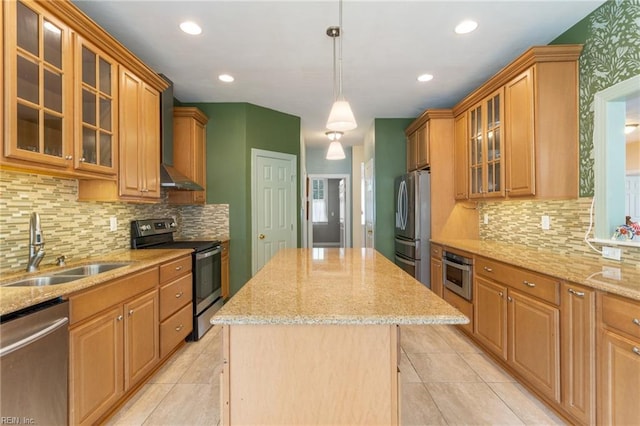 kitchen featuring a sink, a center island, light stone counters, and stainless steel appliances
