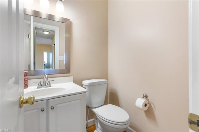 half bath featuring toilet and vanity