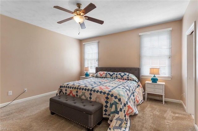 carpeted bedroom with baseboards and ceiling fan