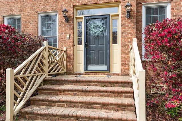 doorway to property with brick siding