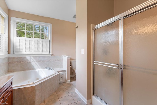 bathroom with a shower stall, tile patterned floors, toilet, and a tub with jets
