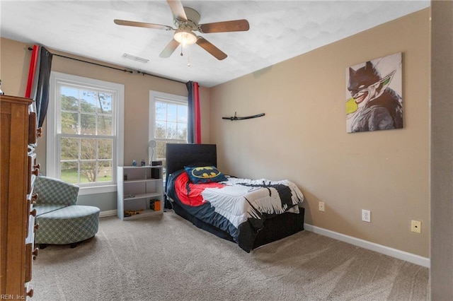 bedroom featuring visible vents, baseboards, multiple windows, and carpet