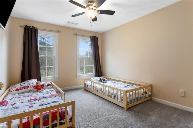 bedroom with a ceiling fan, baseboards, carpet, and visible vents