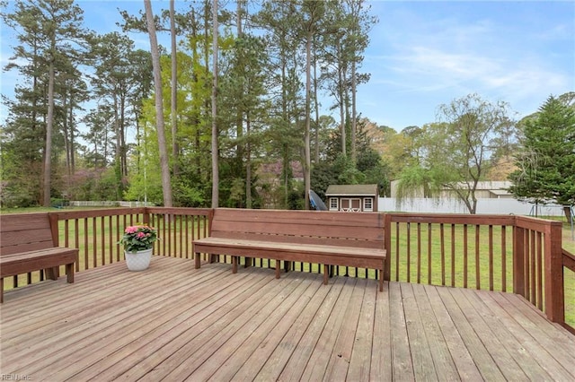 deck featuring a yard, an outdoor structure, and a storage unit