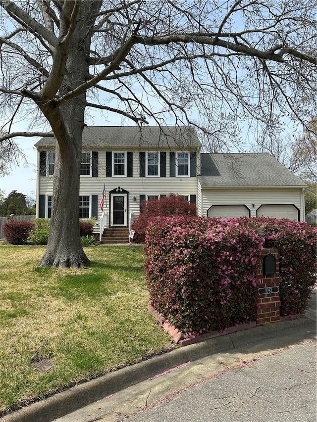 colonial-style house with a garage and a front yard