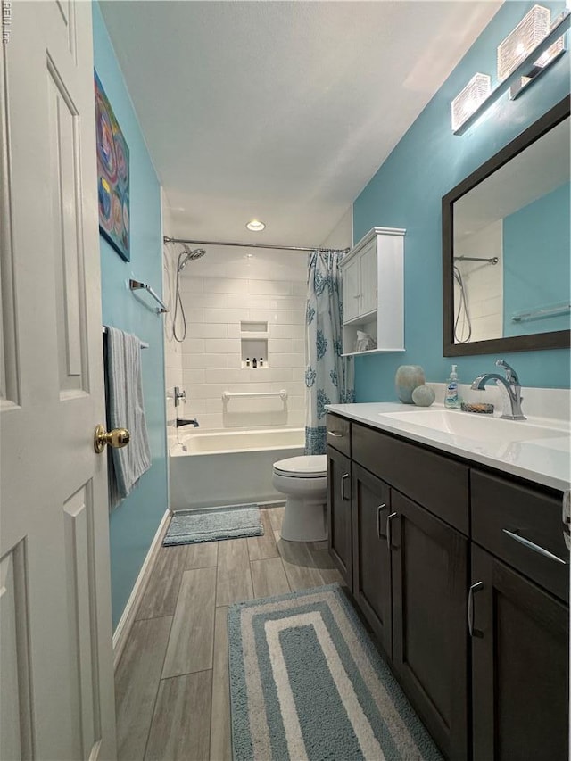full bath featuring vanity, baseboards, wood finish floors, shower / tub combo with curtain, and toilet