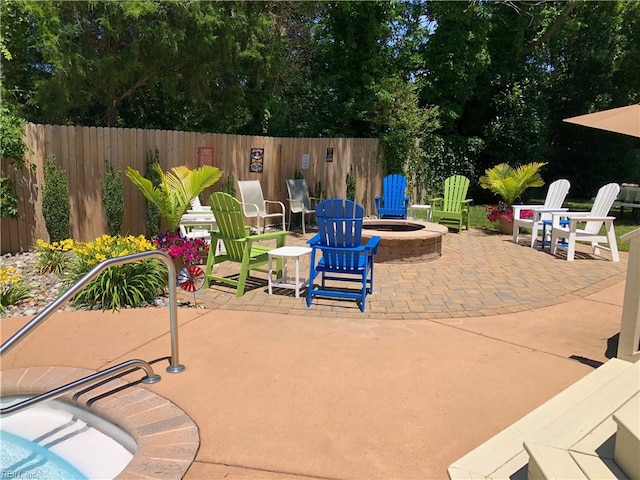 view of patio / terrace with fence and a fire pit