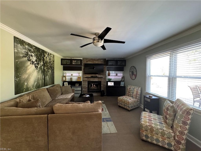 tiled living room with crown molding, a large fireplace, baseboards, and a ceiling fan