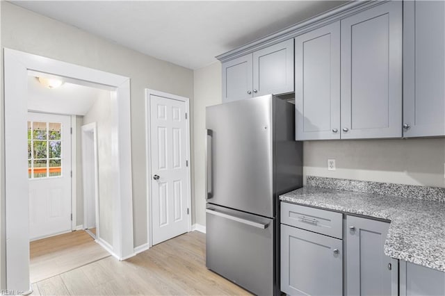 2916 Somme Ave, Norfolk, VA 23509 - kitchen featuring freestanding refrigerator, gray cabinets, light wood-style floors, and baseboards