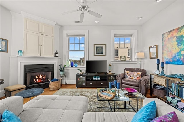 429 York St W Unit 3A, Norfolk, VA 23510 - living room with a warm lit fireplace, wood finished floors, a ceiling fan, and plenty of natural light