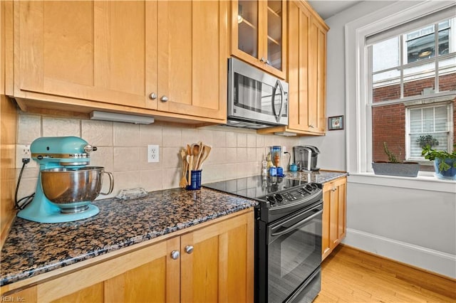 429 York St W Unit 3A, Norfolk, VA 23510 - kitchen featuring glass insert cabinets, stainless steel microwave, black electric range oven, baseboards, and backsplash