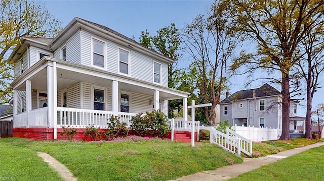 farmhouse inspired home featuring fence, a porch, and a front lawn