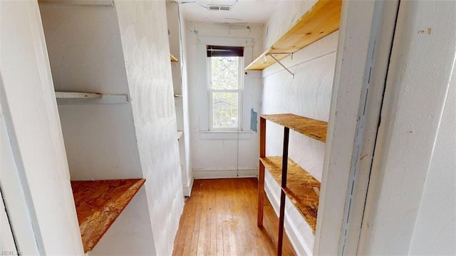walk in closet with wood-type flooring and visible vents