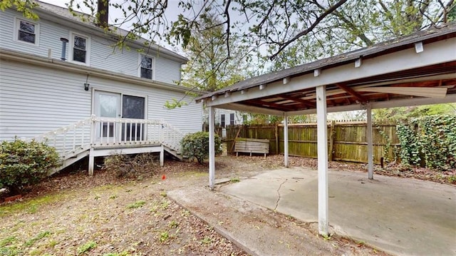 view of patio / terrace featuring a deck and fence