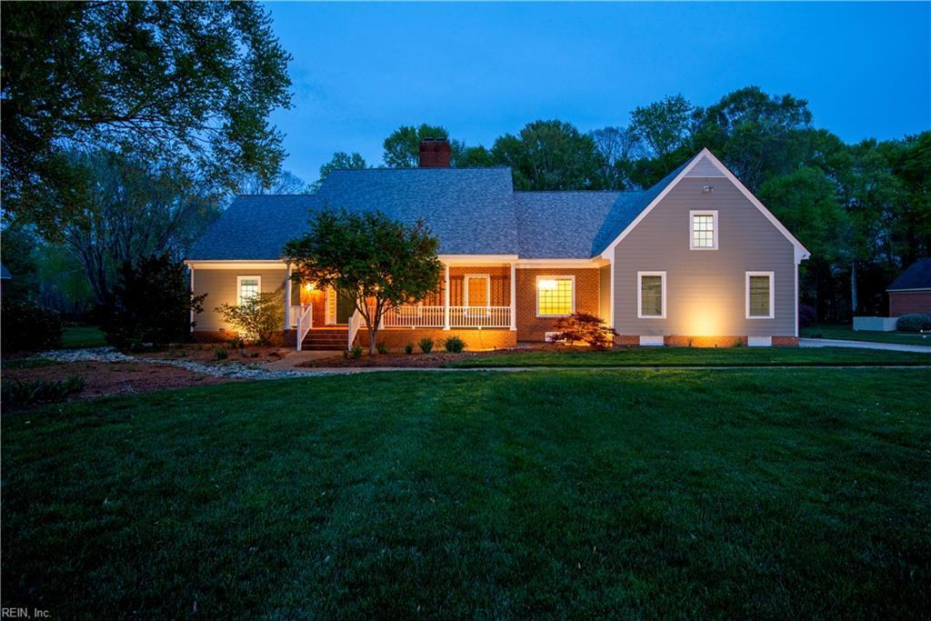 view of front of property featuring a chimney and a front lawn