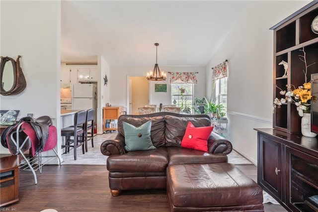 living room featuring a chandelier and wood finished floors