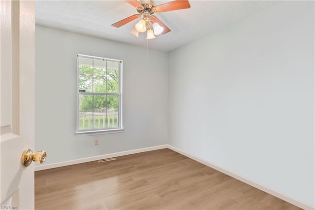 empty room featuring visible vents, baseboards, light wood finished floors, and a ceiling fan