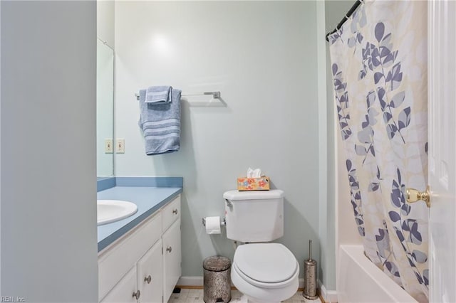 bathroom featuring shower / bath combo, vanity, baseboards, and toilet