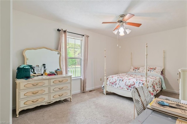 bedroom featuring a ceiling fan and light colored carpet