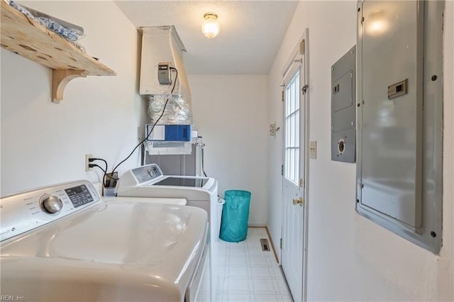 laundry area with washer and dryer, laundry area, baseboards, and light floors