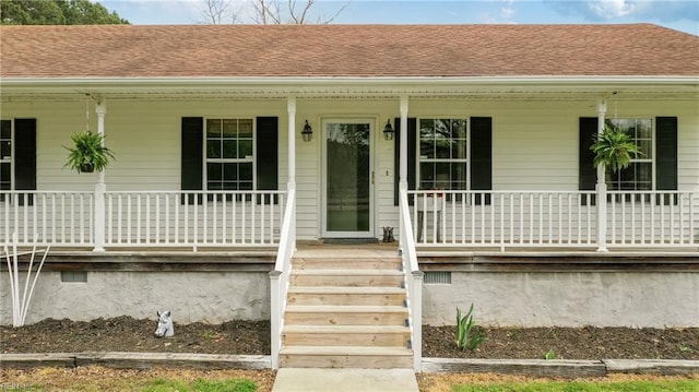 doorway to property featuring crawl space, a shingled roof, and covered porch